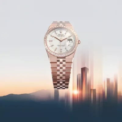 A luxury rose gold Rolex watch with a mother-of-pearl dial and diamond markers is displayed against a blurred city skyline and sunrise background.