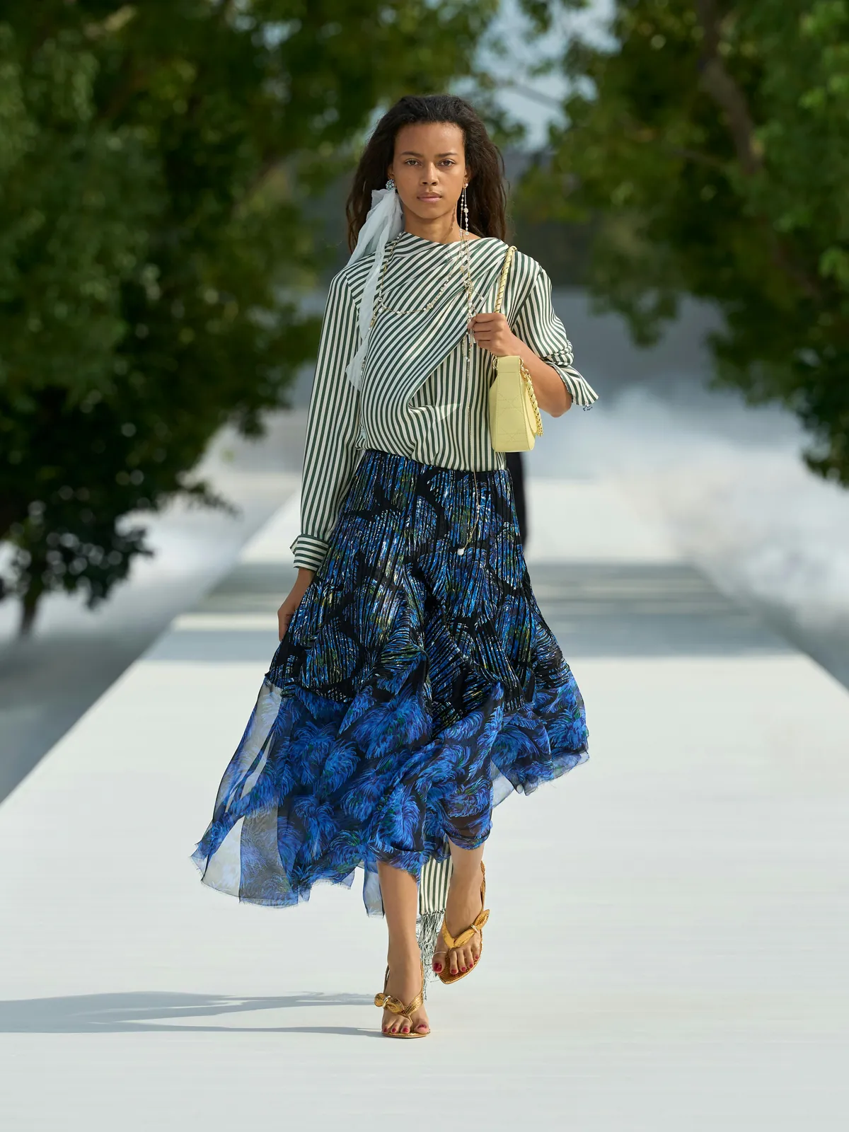Dior Summer 2027 look 9: striped shirt with a draped scarf and a flowing blue printed skirt
