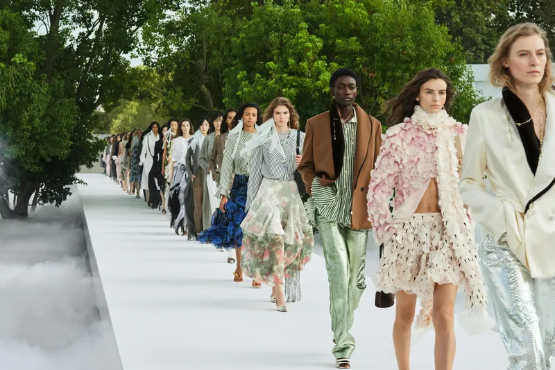 Finale of the Dior Summer 2027 women's show: models on a white runway lined with trees and mist