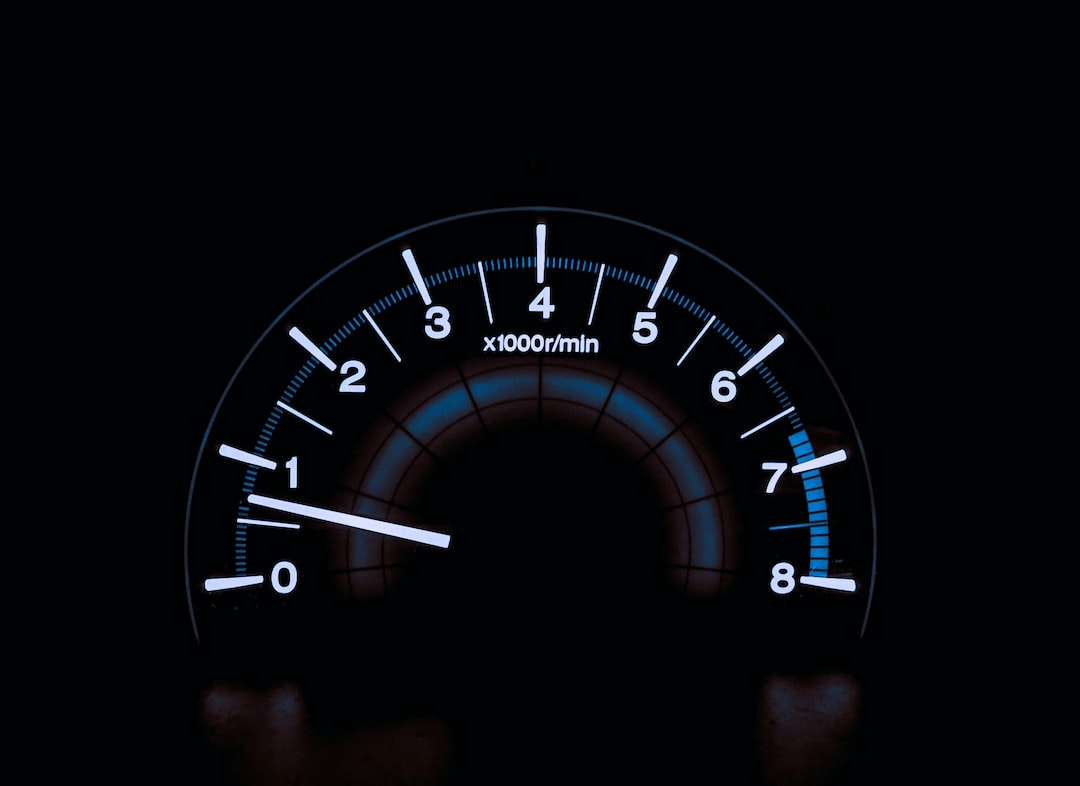 A close-up of an illuminated car tachometer showing just above 1,000 revolutions per minute, with a scale from 0 to 8 x 1,000 rpm—an essential detail often discussed in exclusive interviews with top automotive designers.