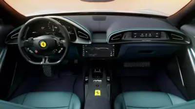 Luxury defines the Ferrari car interior, boasting a digital dashboard, multifunction steering wheel with Ferrari logo, central touchscreen, and premium leather seats.