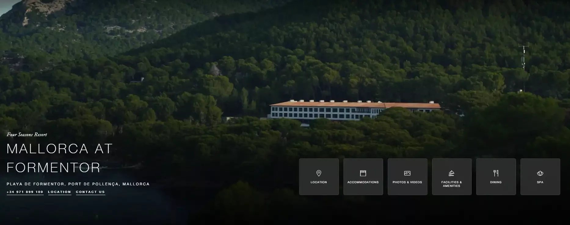 A large white luxury building with a red roof is nestled among dense green trees in a mountainous area. Text overlay reads "Mallorca at Formentor" with navigation options.