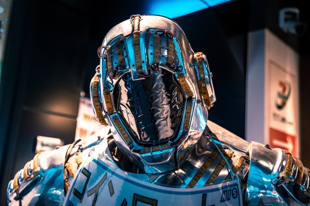 A close-up view of a metallic humanoid robot with a reflective, featureless face and intricate wires embodies Hublot’s Fusion Philosophy—seamlessly blending tradition with innovation in an extraordinary design.