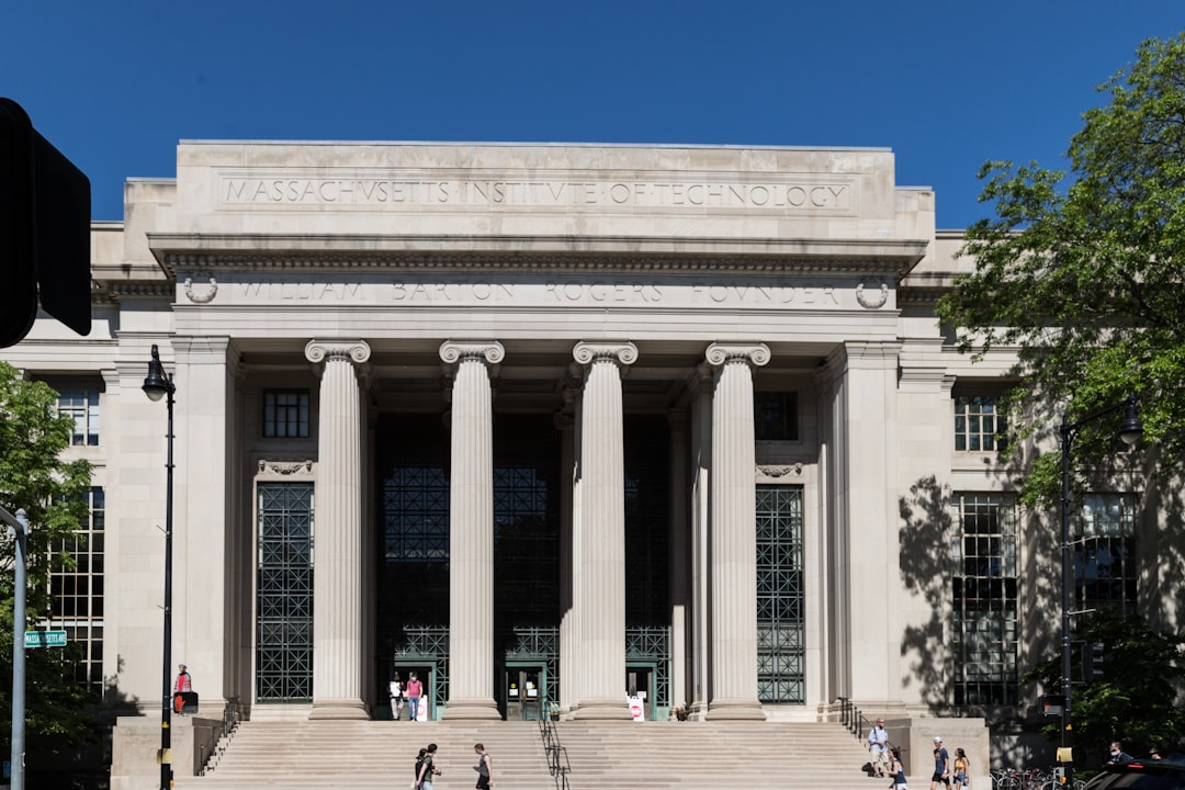 A neoclassical building with tall columns and large windows, labeled "Massachusetts Institute of Technology" and "William Barton Rogers Founder," makes a striking stop for luxury family travel or an educational vacation with kids.