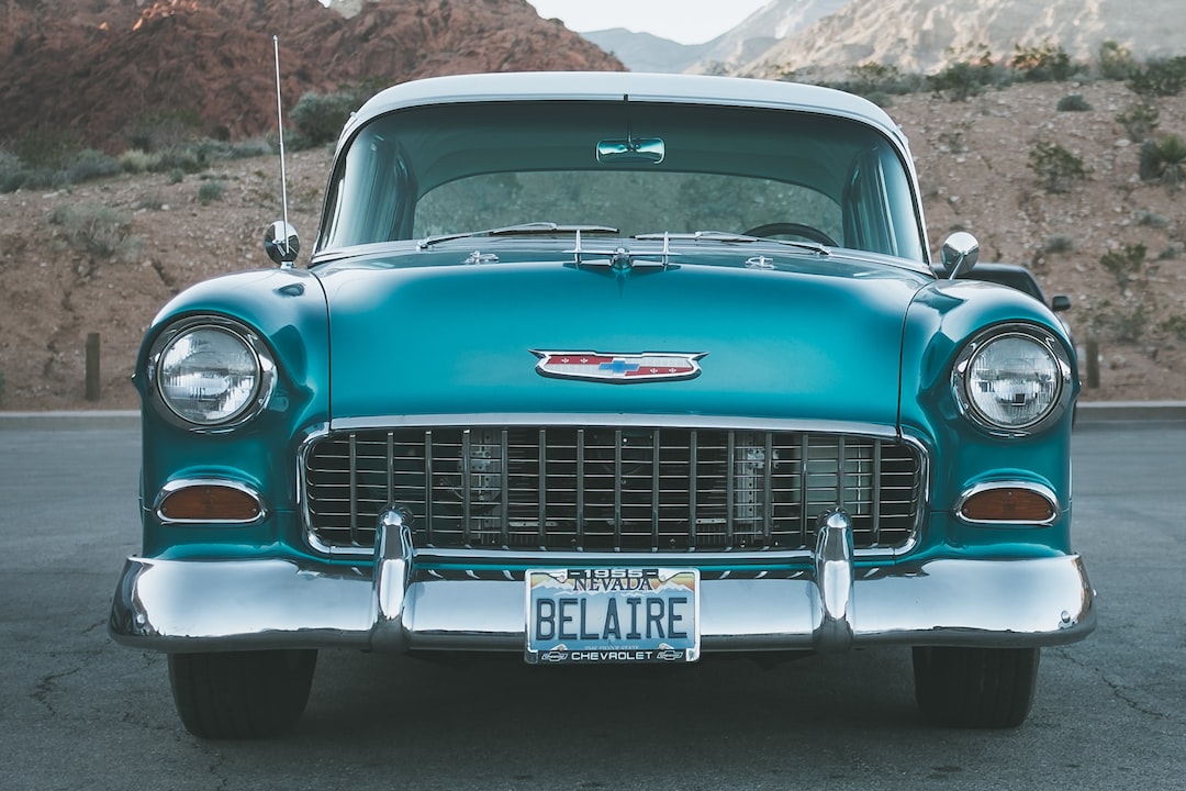 Front view of a vintage turquoise Chevrolet Bel Air, license plate "BELAIRE," parked outdoors against mountain scenery—capturing pure Showtime Splendor reminiscent of classic Las Vegas shows.