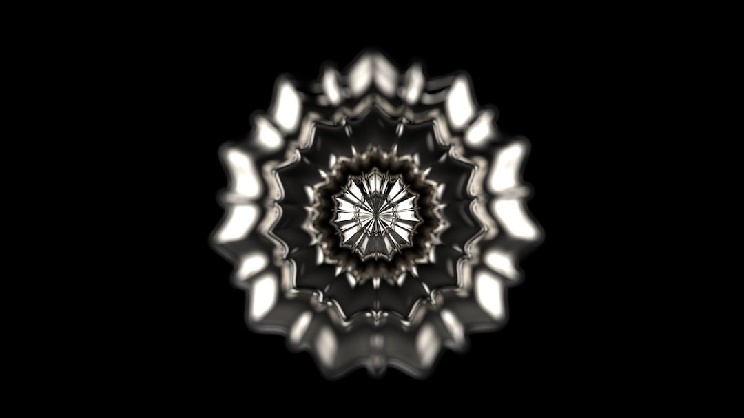 A symmetrical, abstract pattern with metallic, wavy layers radiates from a central point against a solid black background, echoing the enchantment of Van Cleef & Arpels’ nature-inspired designs.